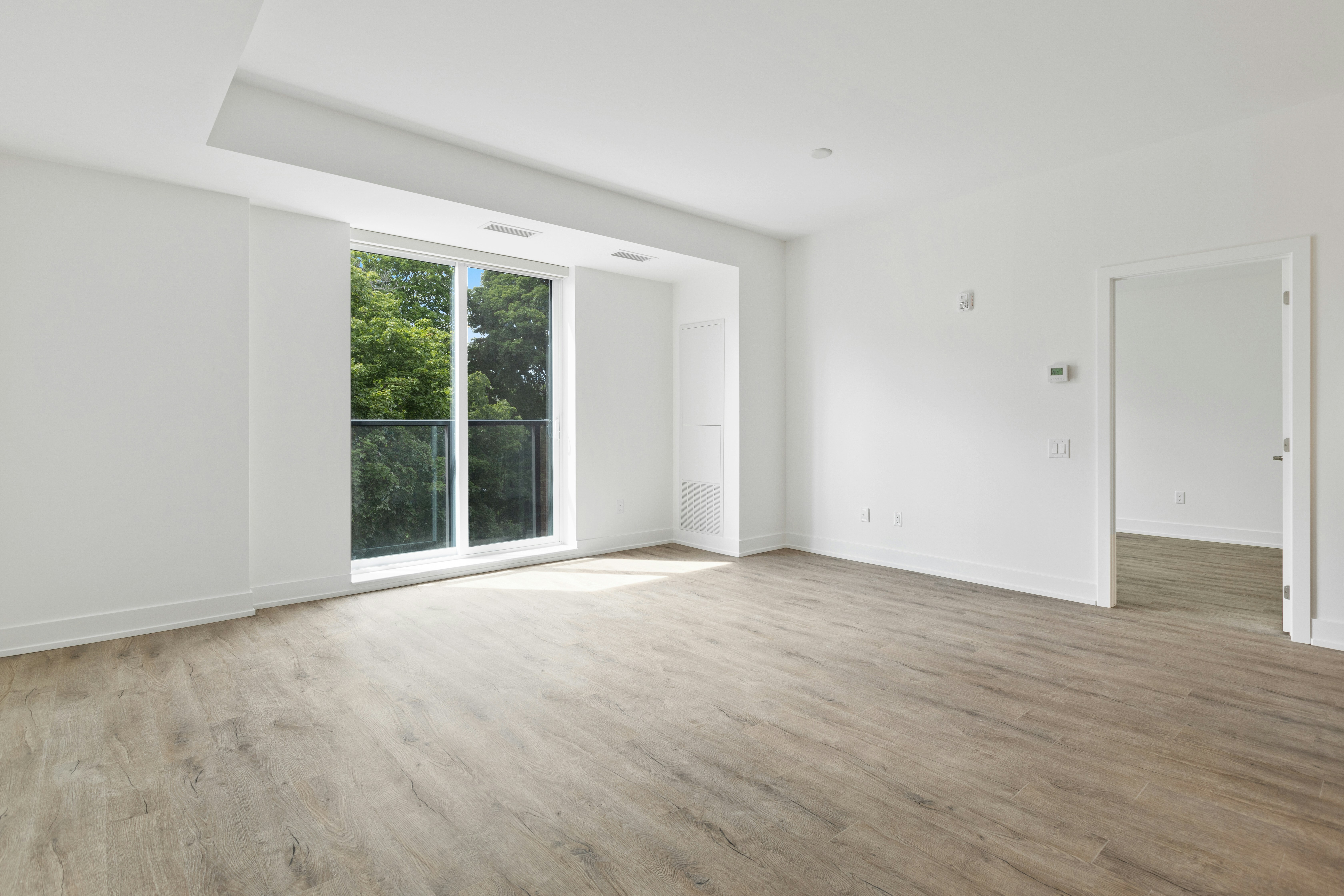 Bright, empty living room with clean wood floors